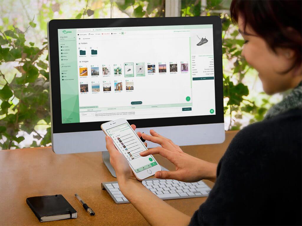 Mac and iPhone being used by woman showing Img.vision dashboard