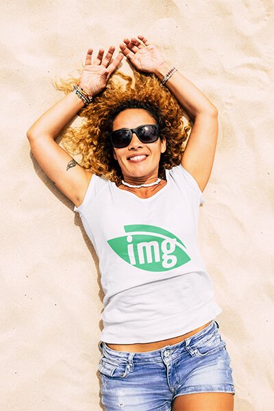 Woman lying in the sand with an Img.vision t-shirt